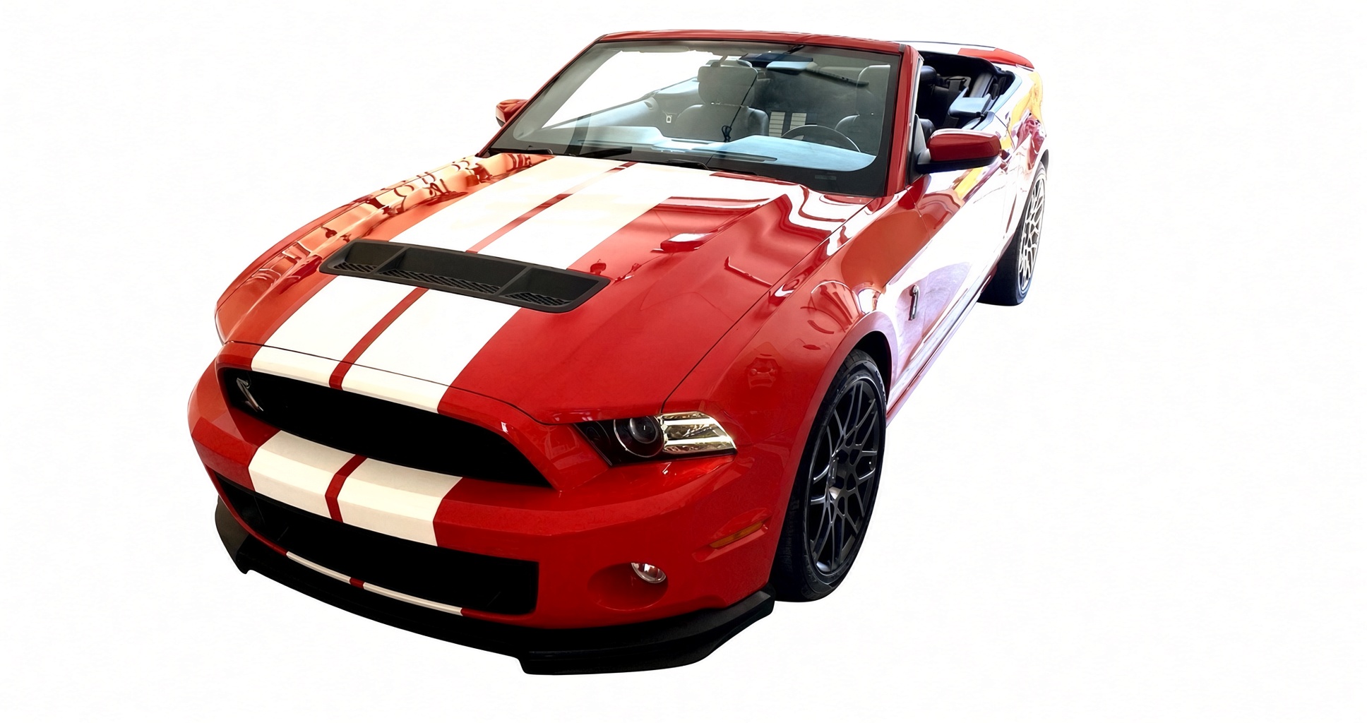Studio photograph of Kenny LeMans, the Race Red 2014 Shelby GT500, white Le Mans stripes on a white backdrop.
